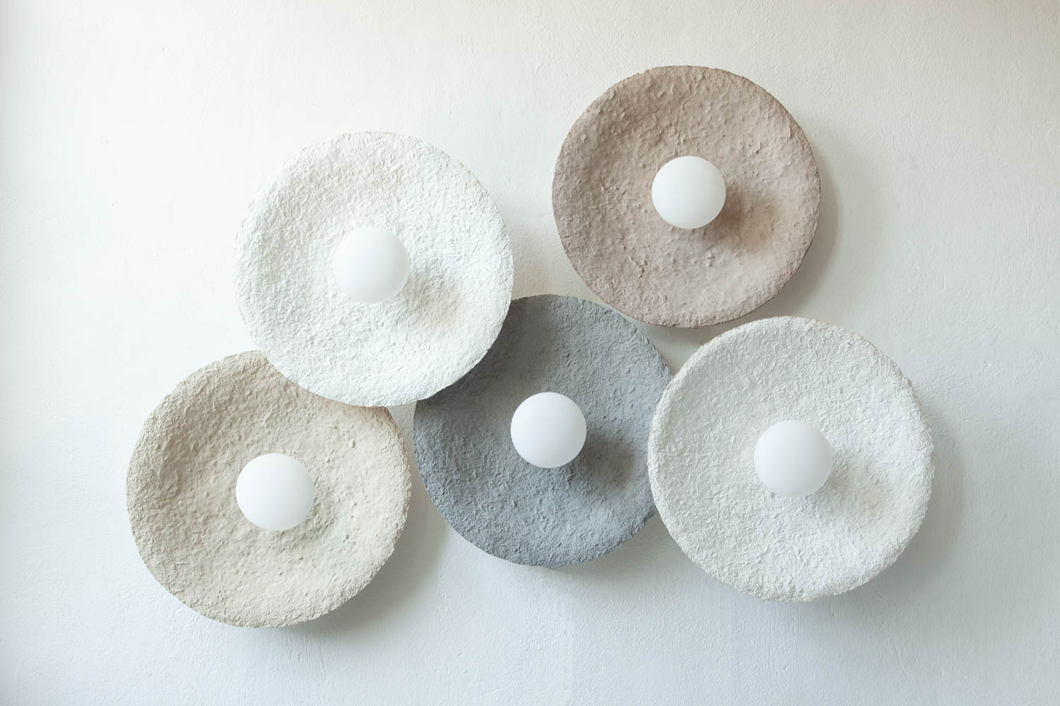 circular wall sconces in pastel hues