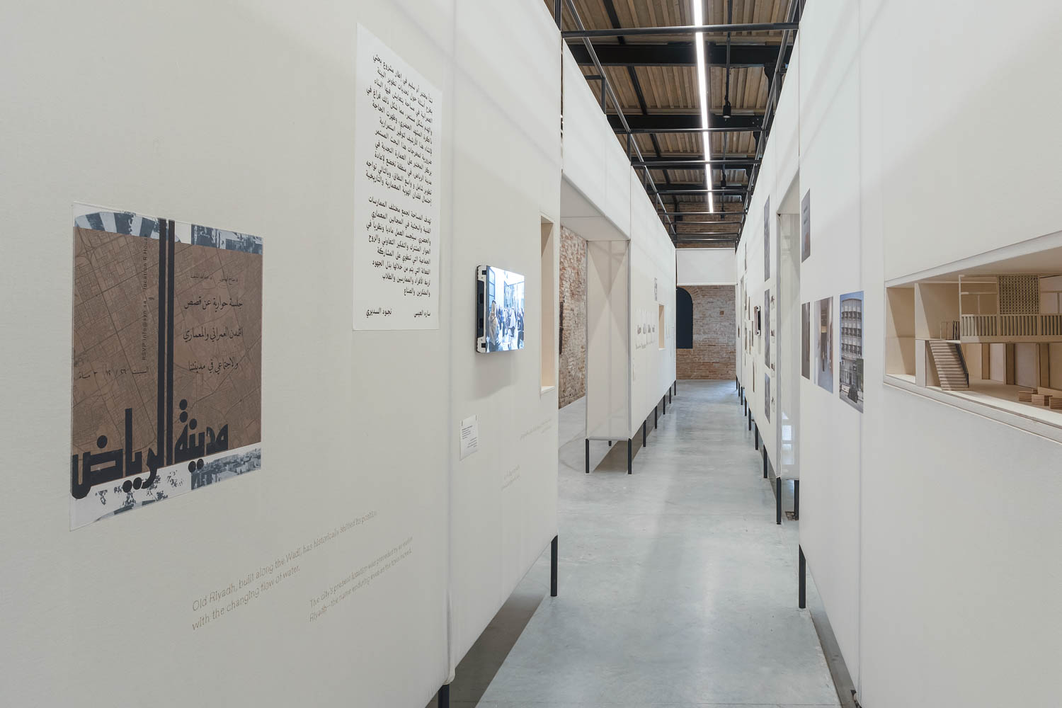 a long white hallway with text and images