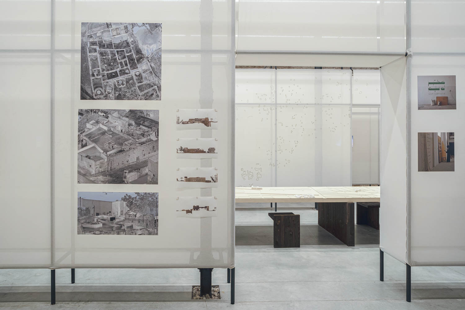 photos on white walls of a pavilion