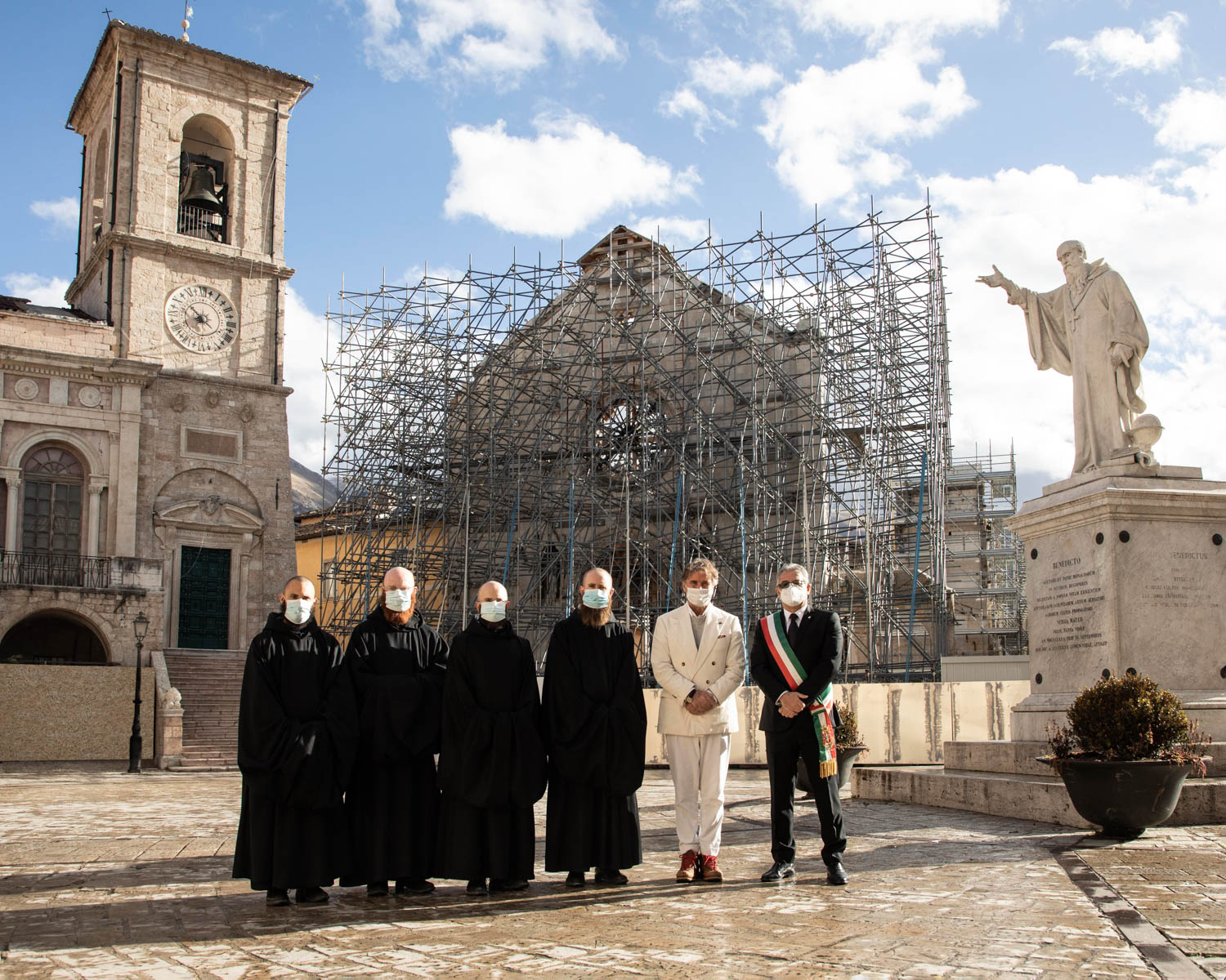 multiple people standing in church courtyard