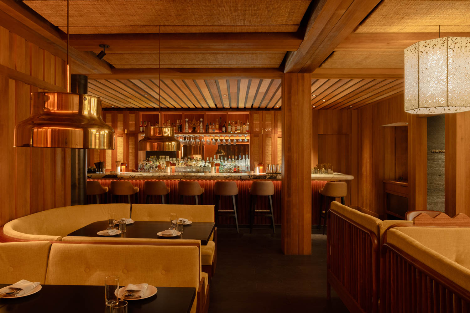 interior of dimly lit restaurant with booths