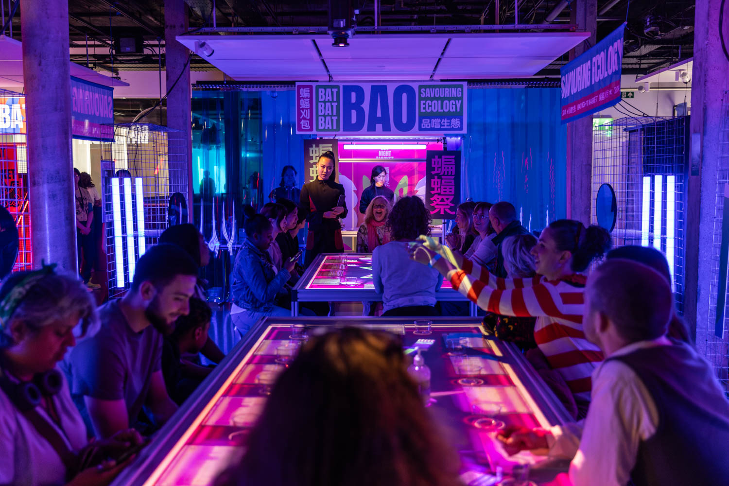 interior shot of people in a dark neon lit room