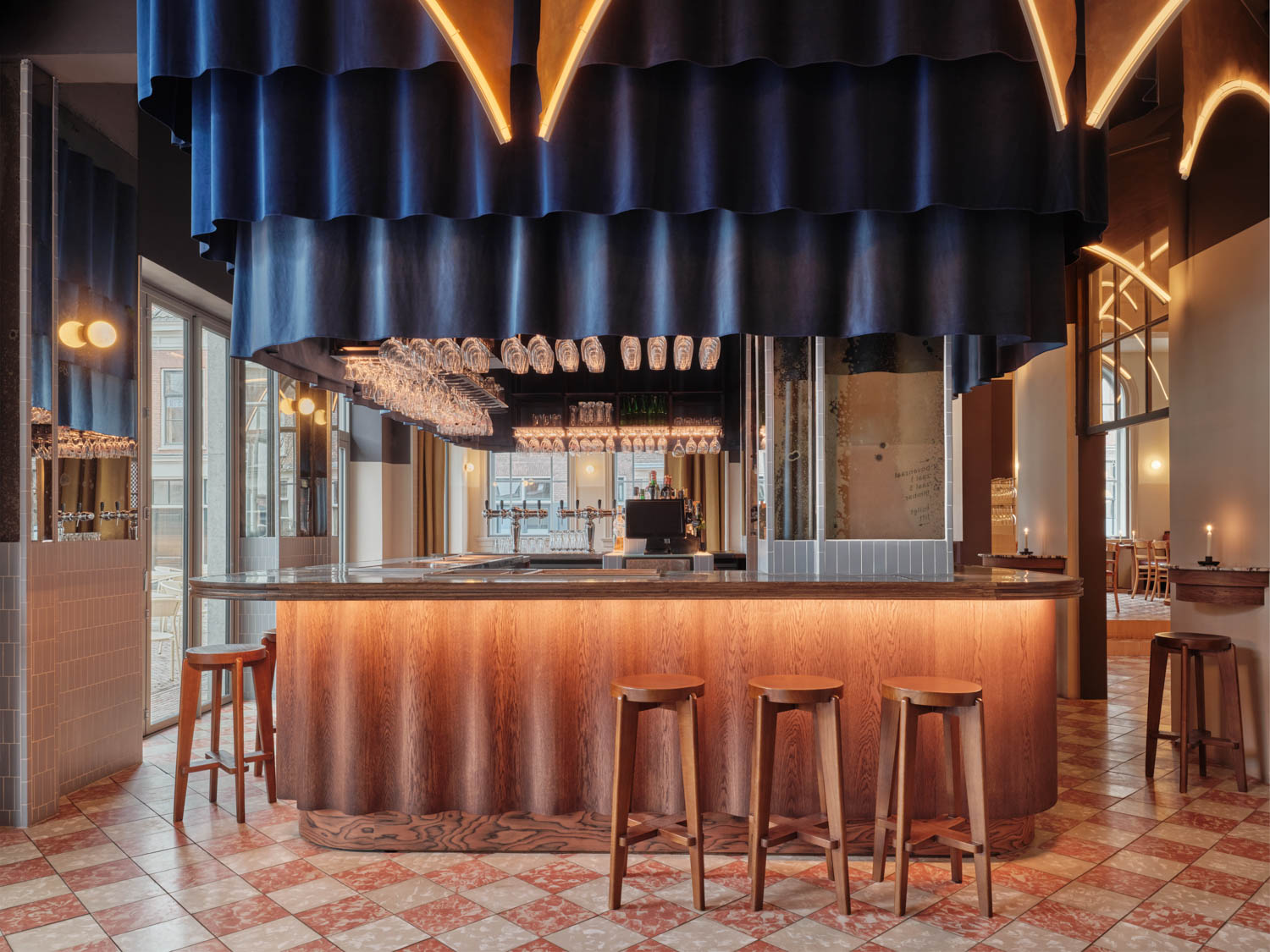 bar area inside of restaurant with dark blue covers