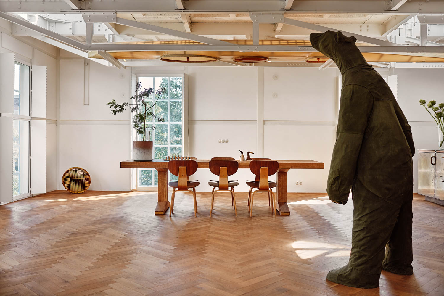 living room with dining table and large bear sculpture