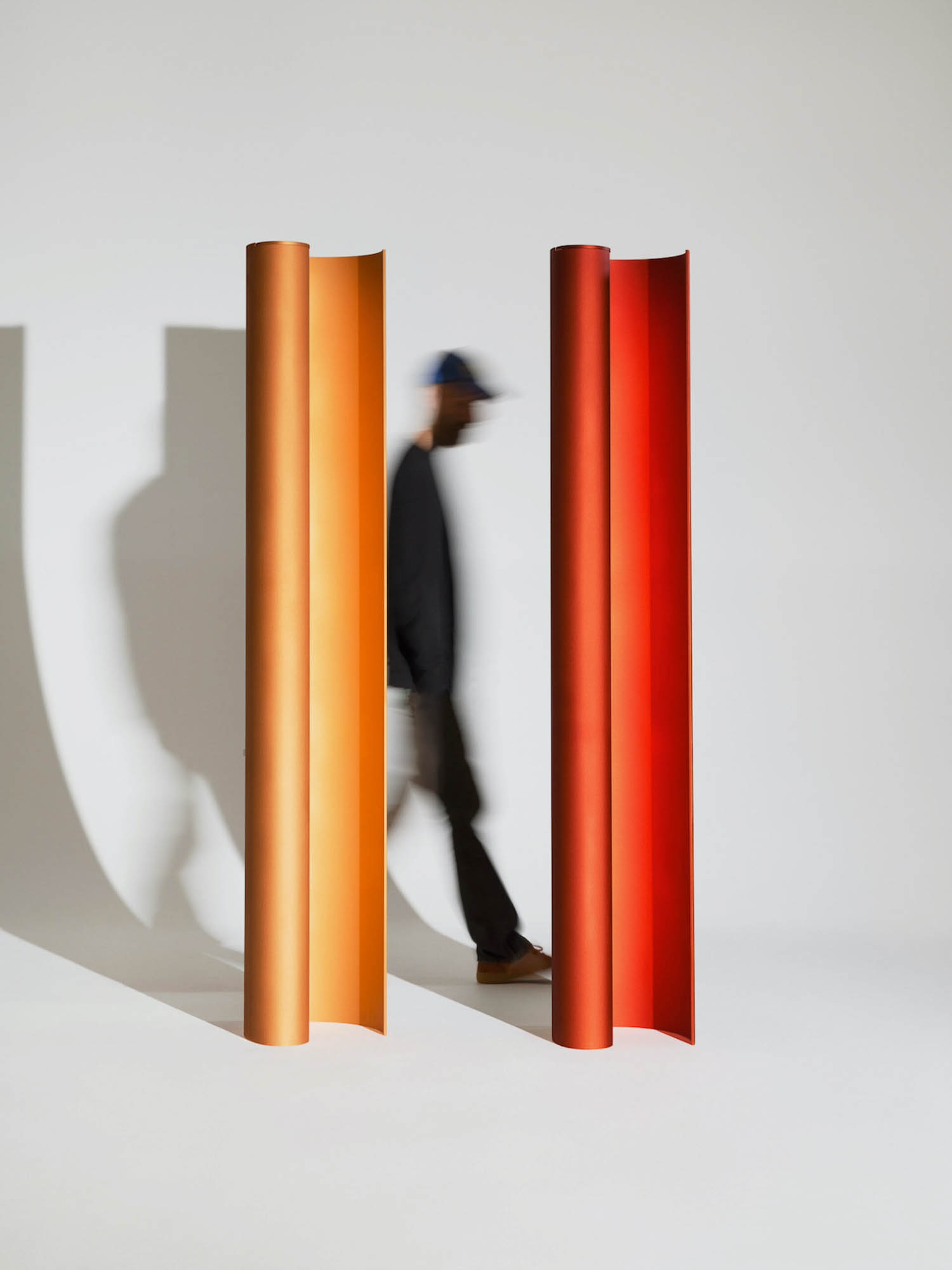 person walking in between two tall columns