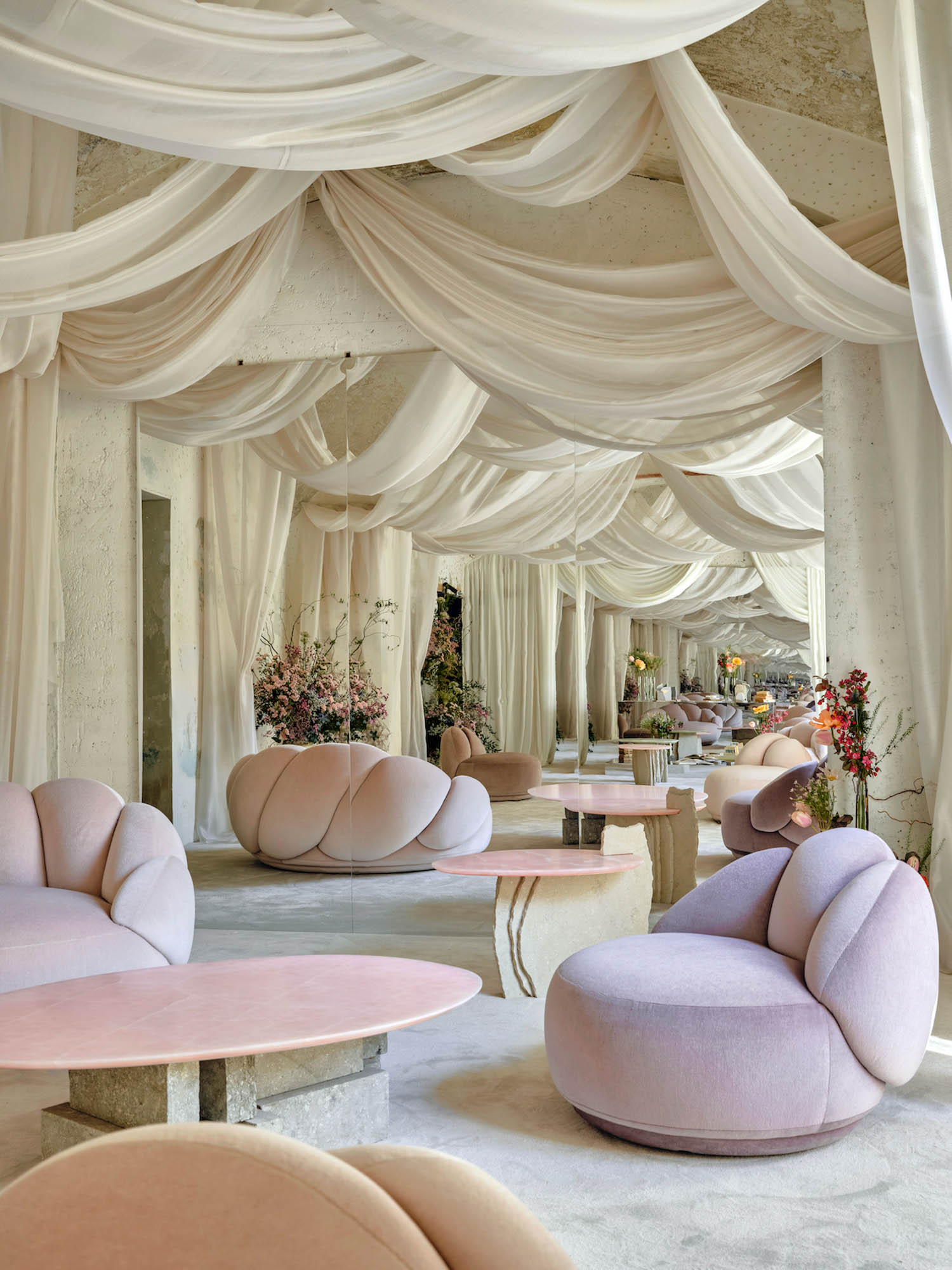 multiple velvet chairs under white canopy