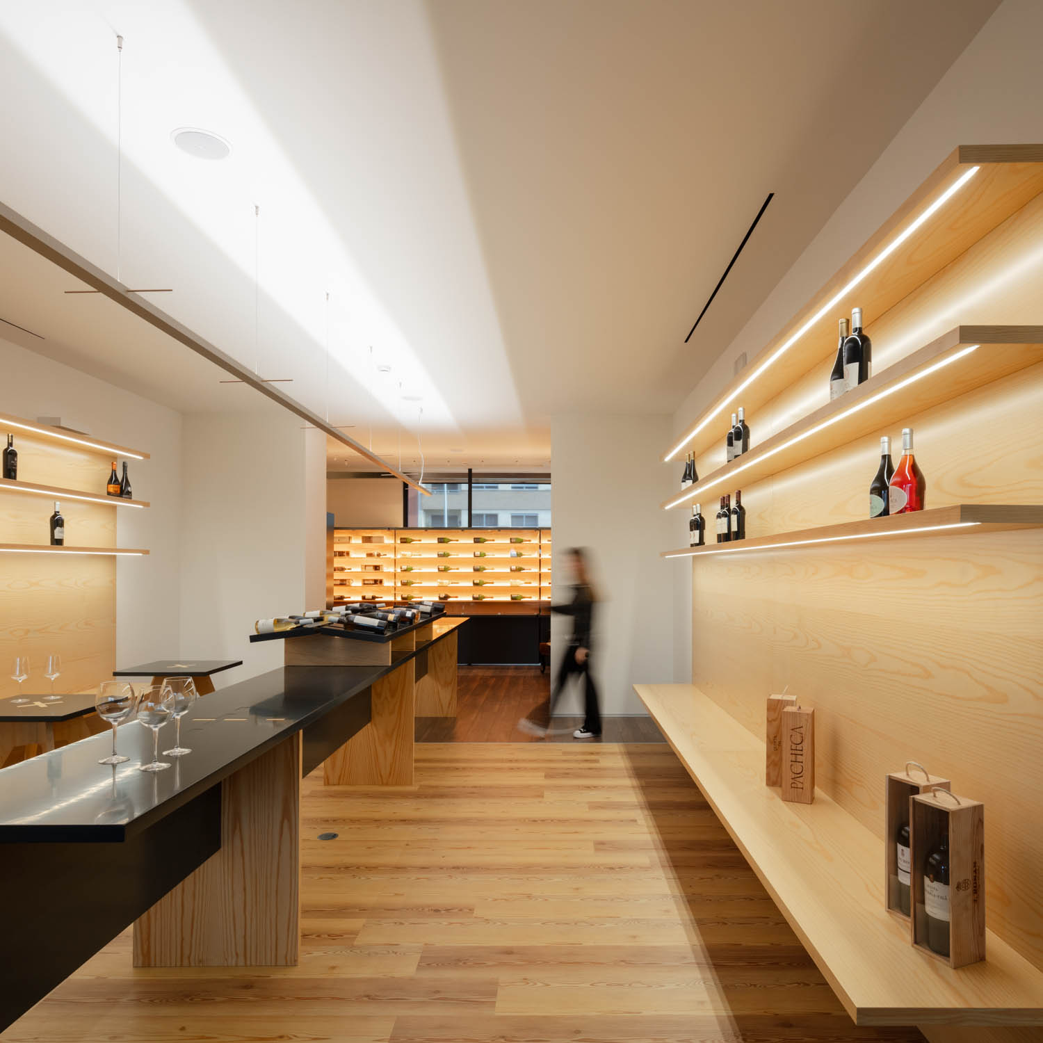 room with wooden shelves and black tables