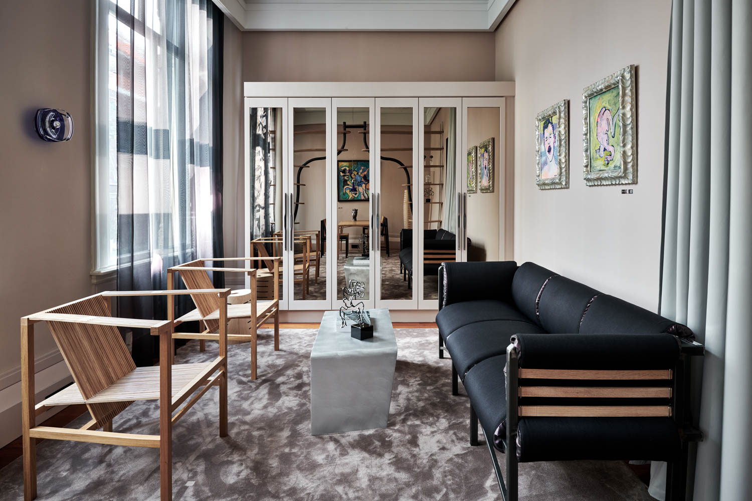 suite room with view of bedroom and mirrored walls