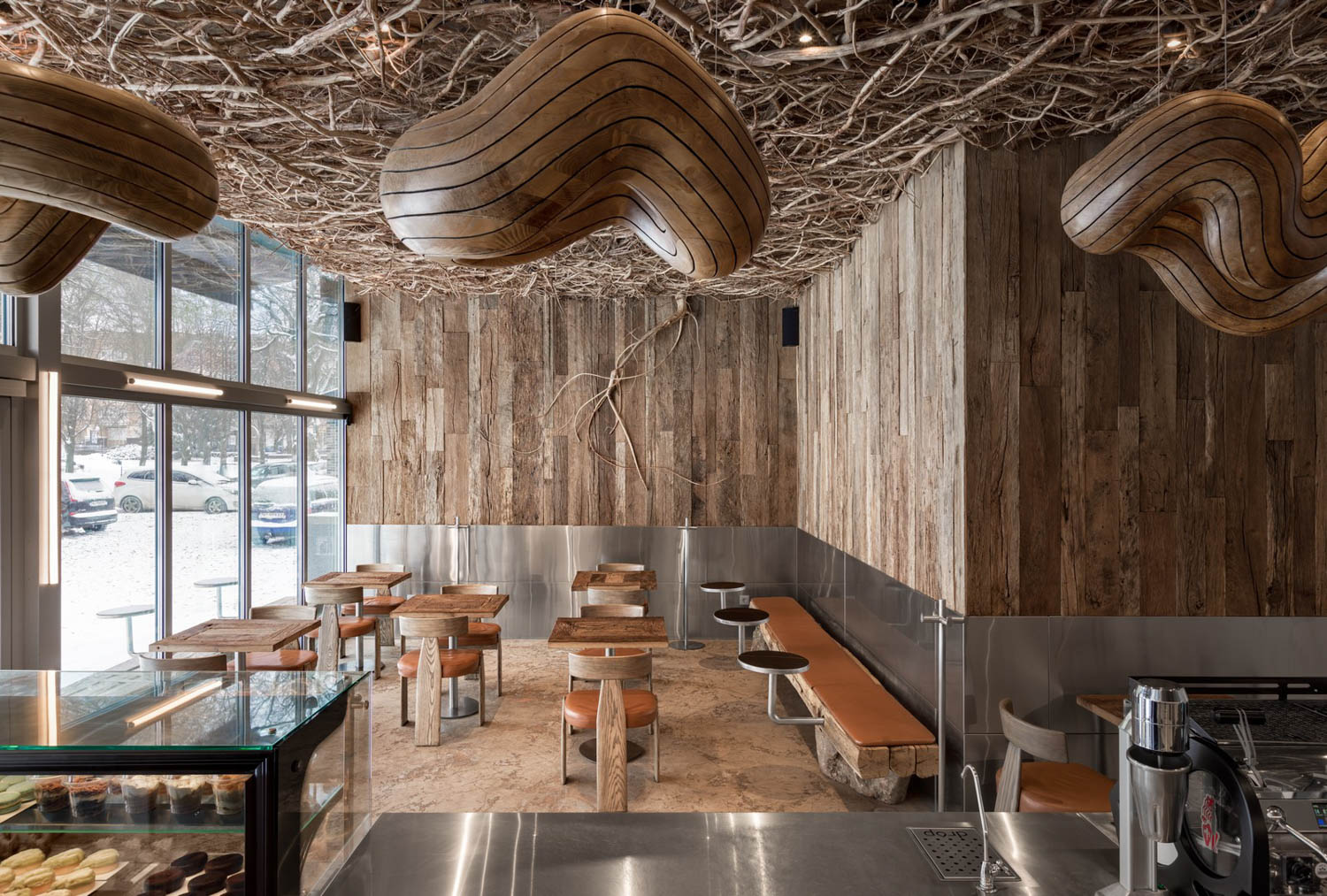cafe area with wooden walls and sculptural chandelier