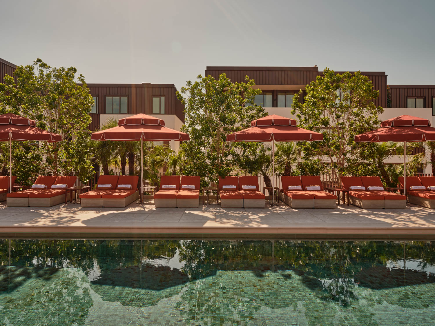 orange umbrellas next to the pool