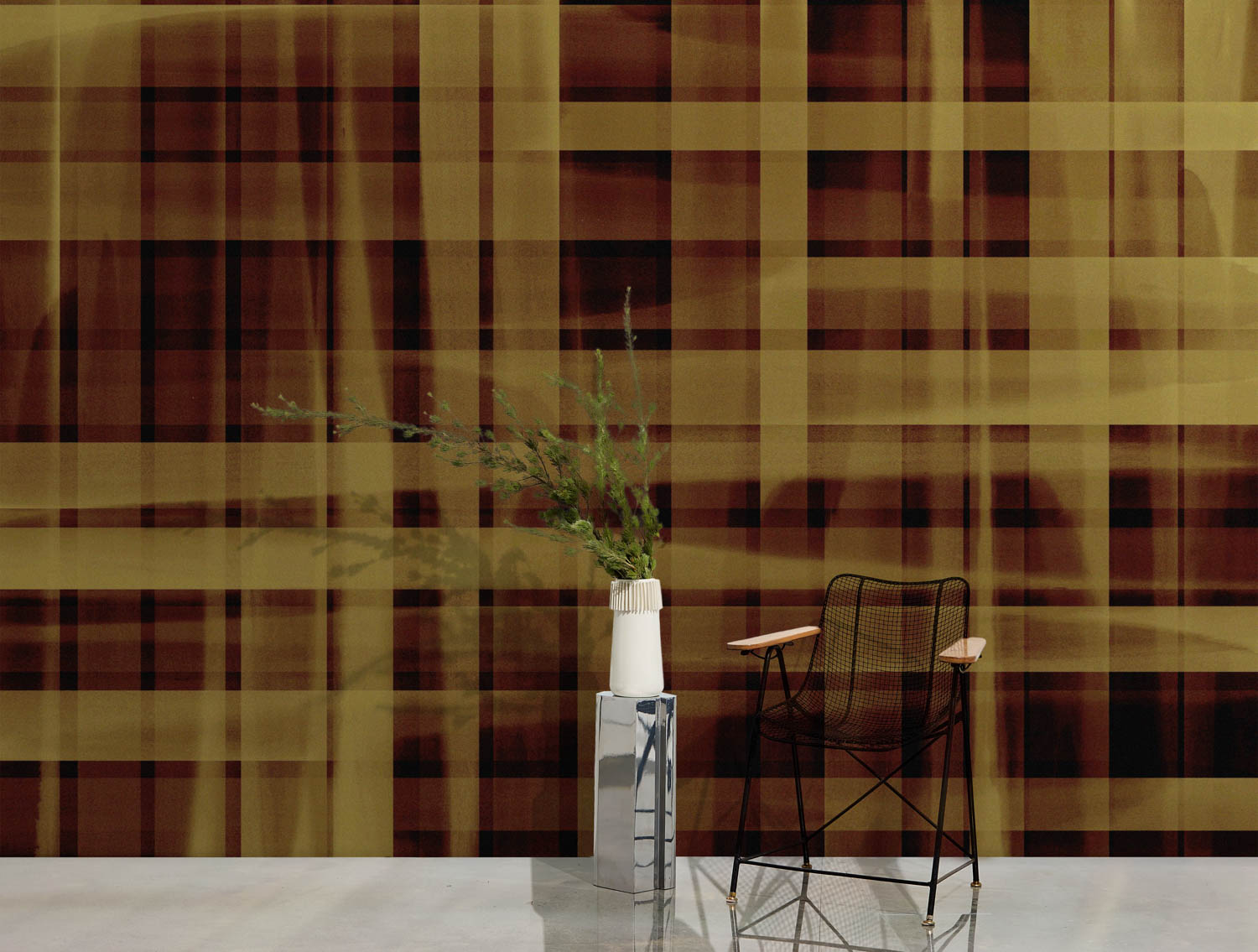 wire framed chair in front of a tartan background