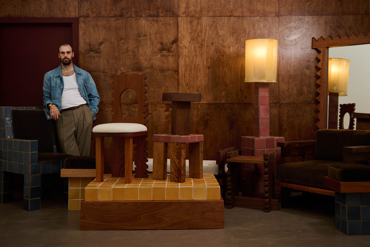person standing next to a handmade furniture collection