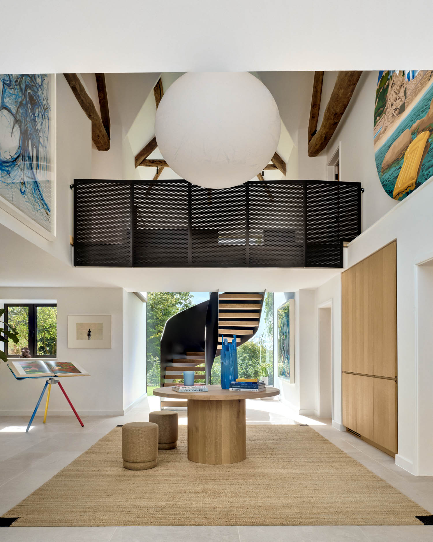 double-height entry hall with view of staircase and round orb light