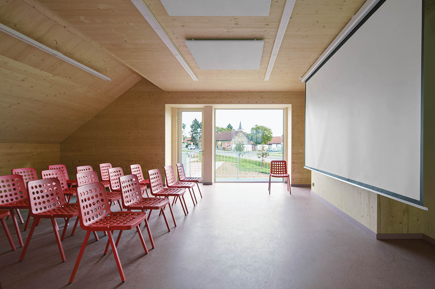 a room with many red chairs