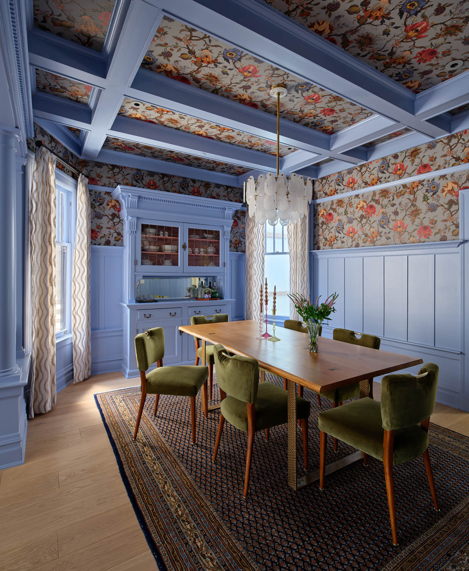 dining room with blue cabinet and floral ceiling
