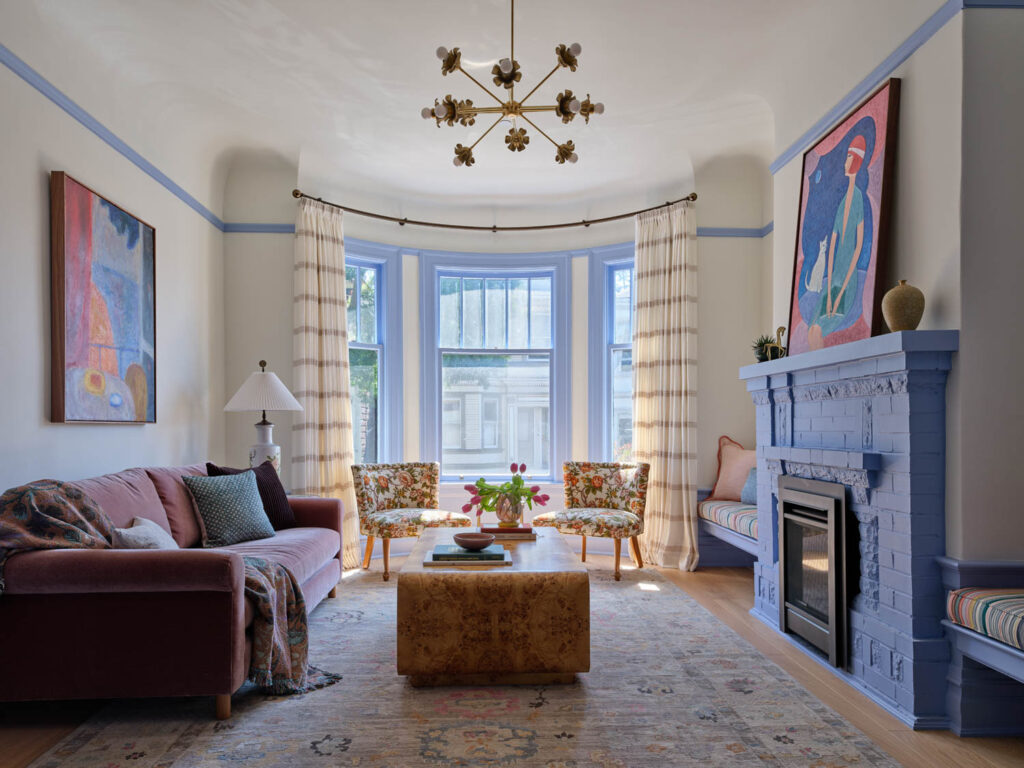 living room with blue fireplace and bay window