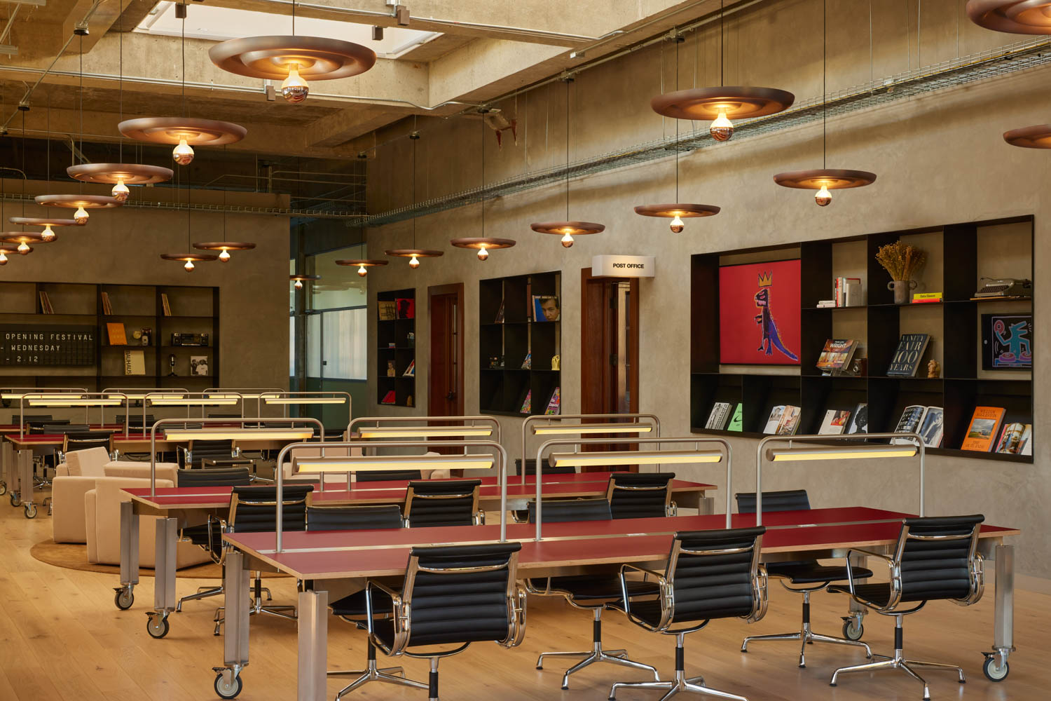 library area with multiple red tables and black shelves