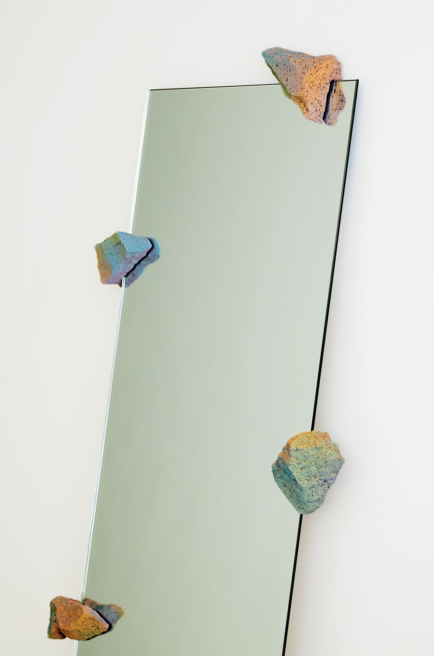 A mirror with a bunch of rocks on it.
