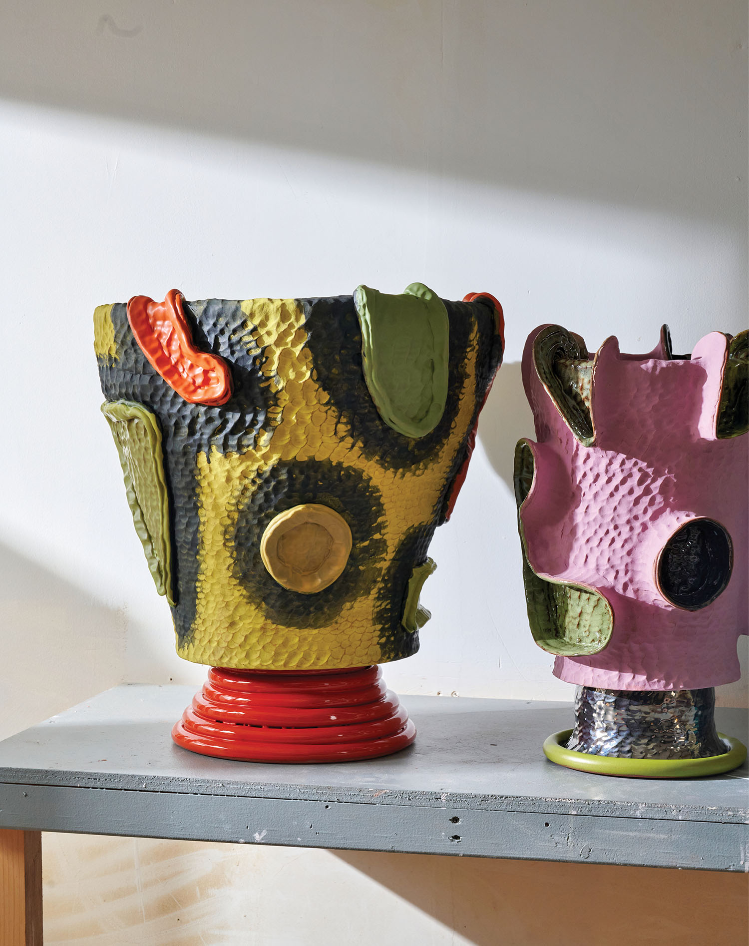 Two vases on a shelf.