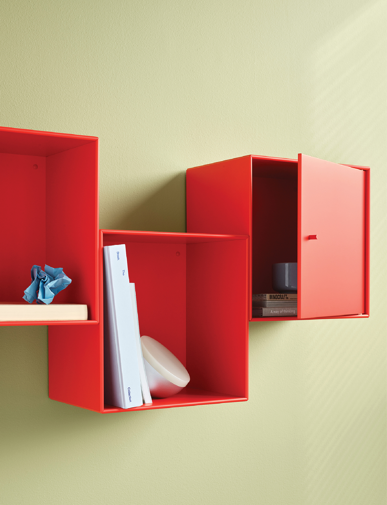 A red shelf with a book and a blue bird.