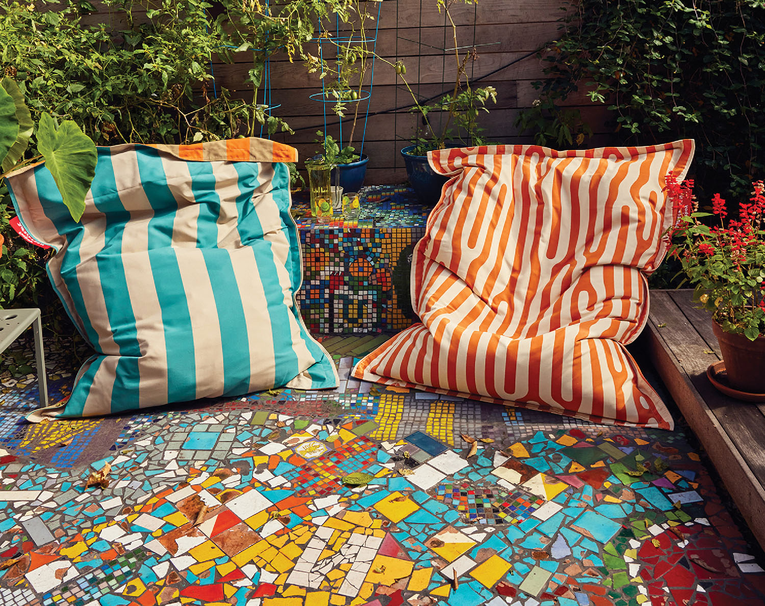 A colorfully painted bench with a pillow and a pillow