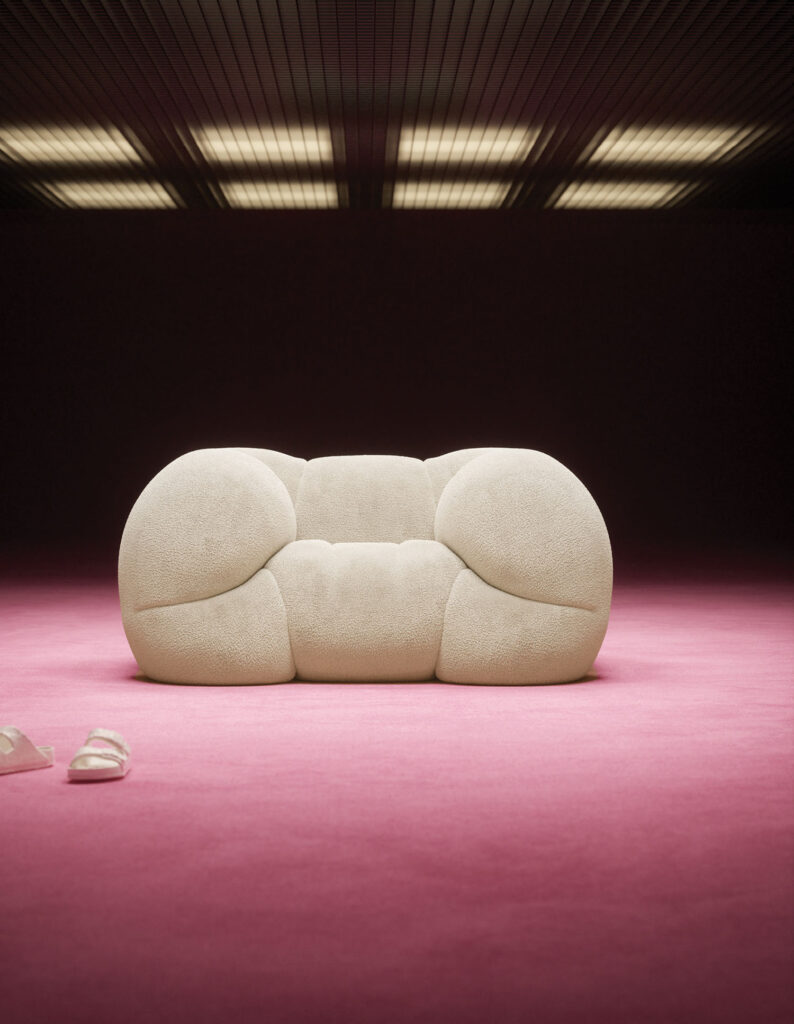 A stuffed bear laying on a pink carpet.