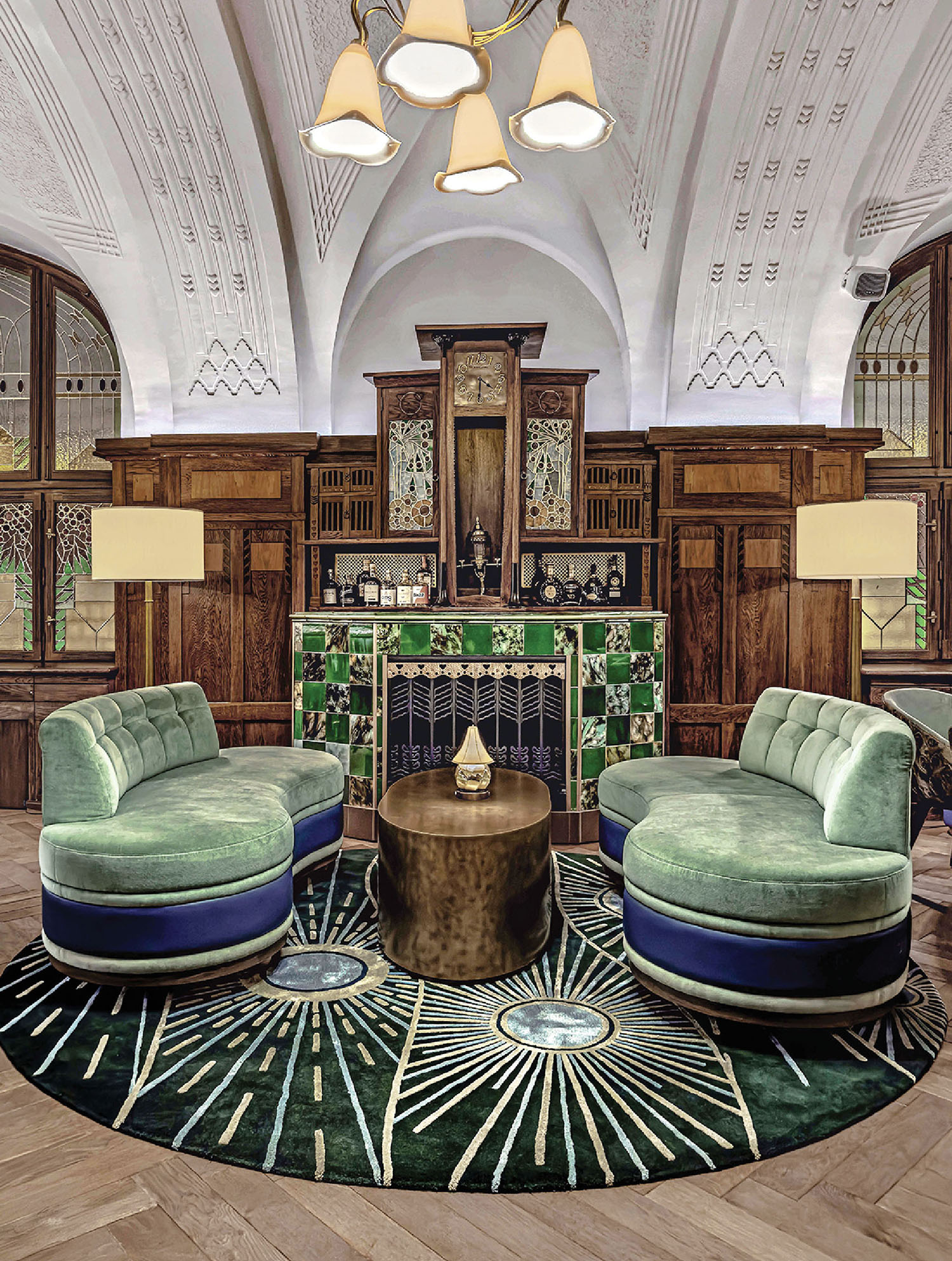 A living room with a large rug and a round table.