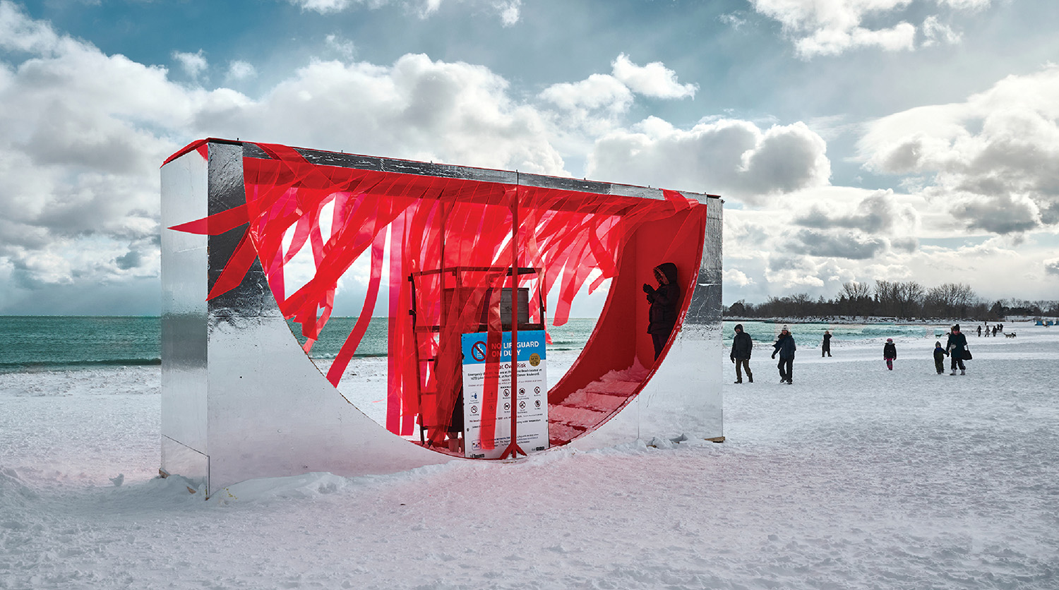 A red sculpture on the beach.