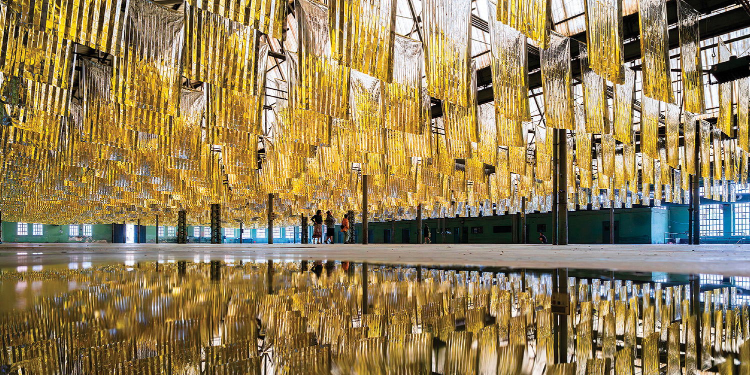 A large yellow sculpture in a building.