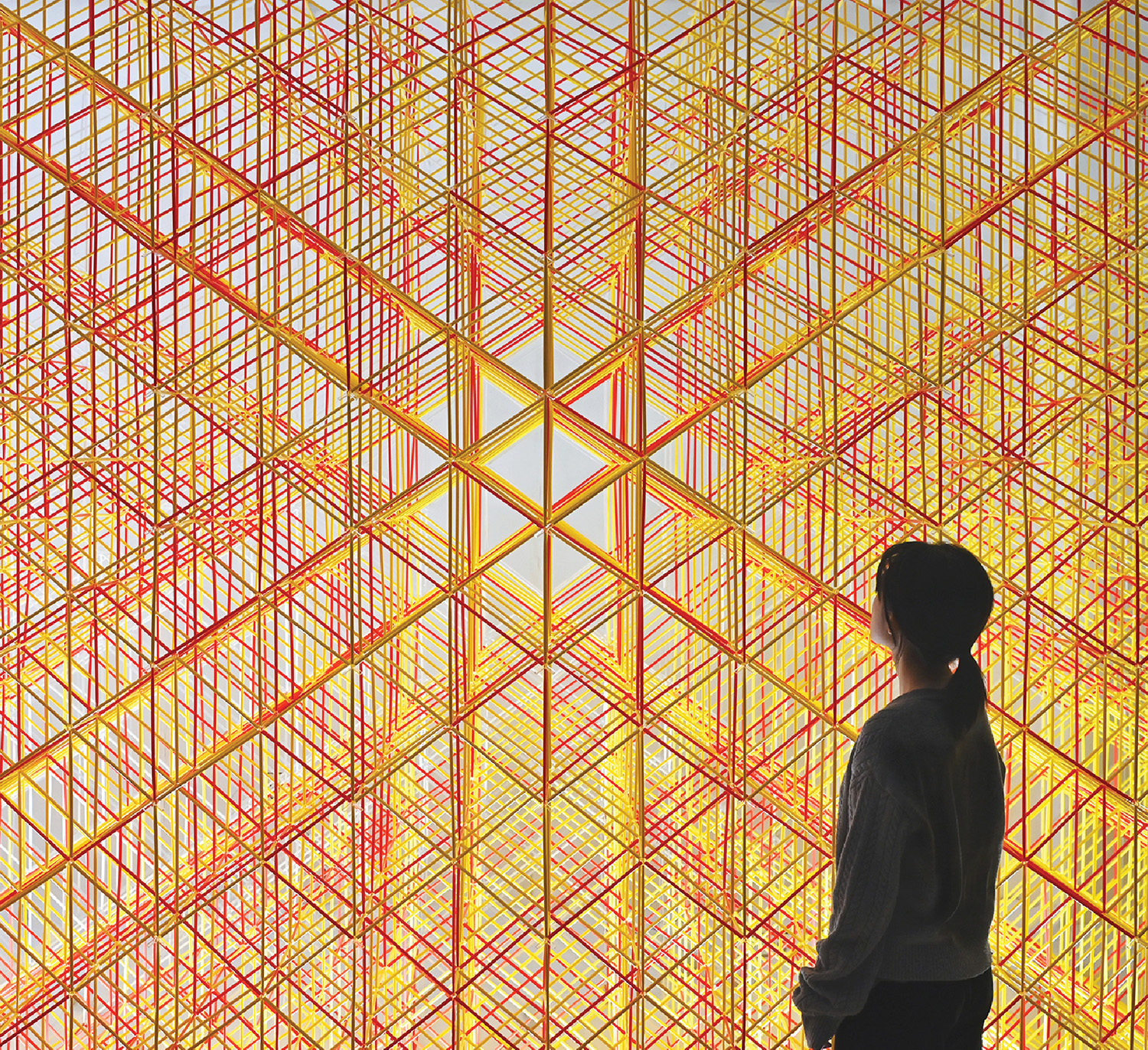 A woman standing in front of a large wall.