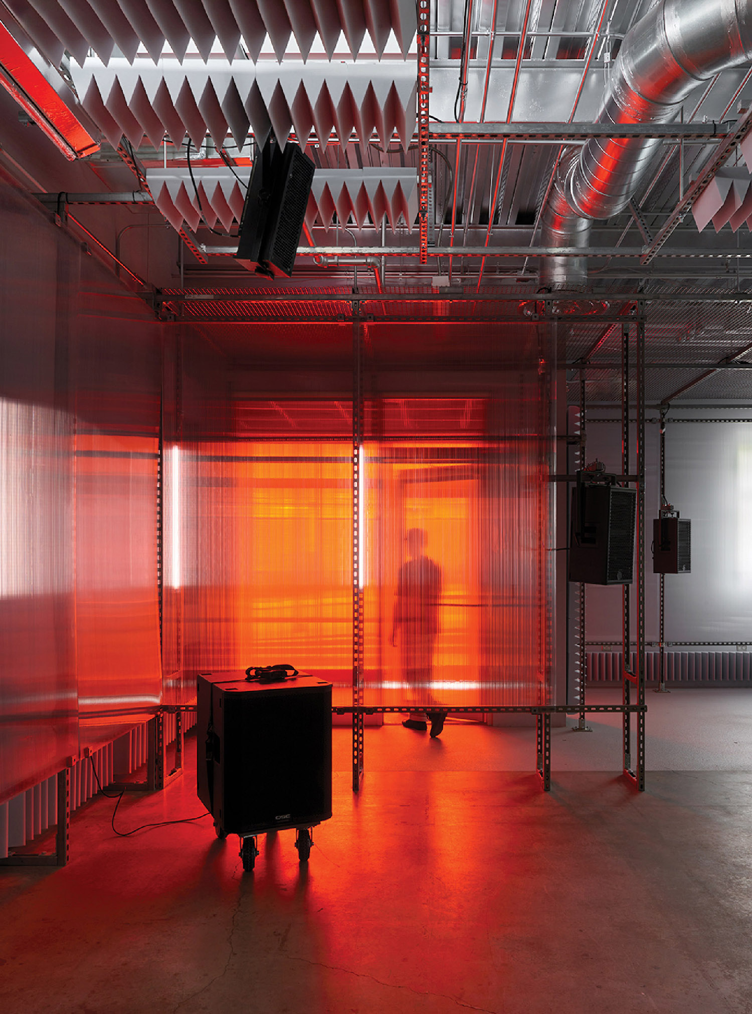 A room with a piano and a speaker.