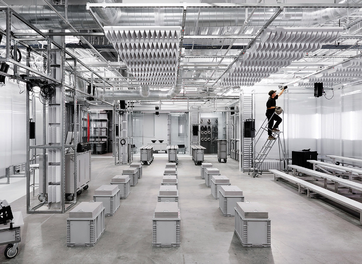A man is standing on a ladder in a room.