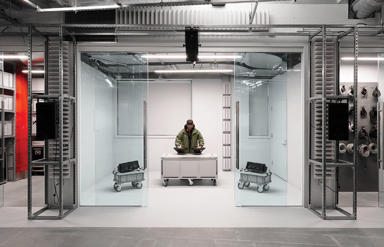 A man sitting in a room with a laptop.