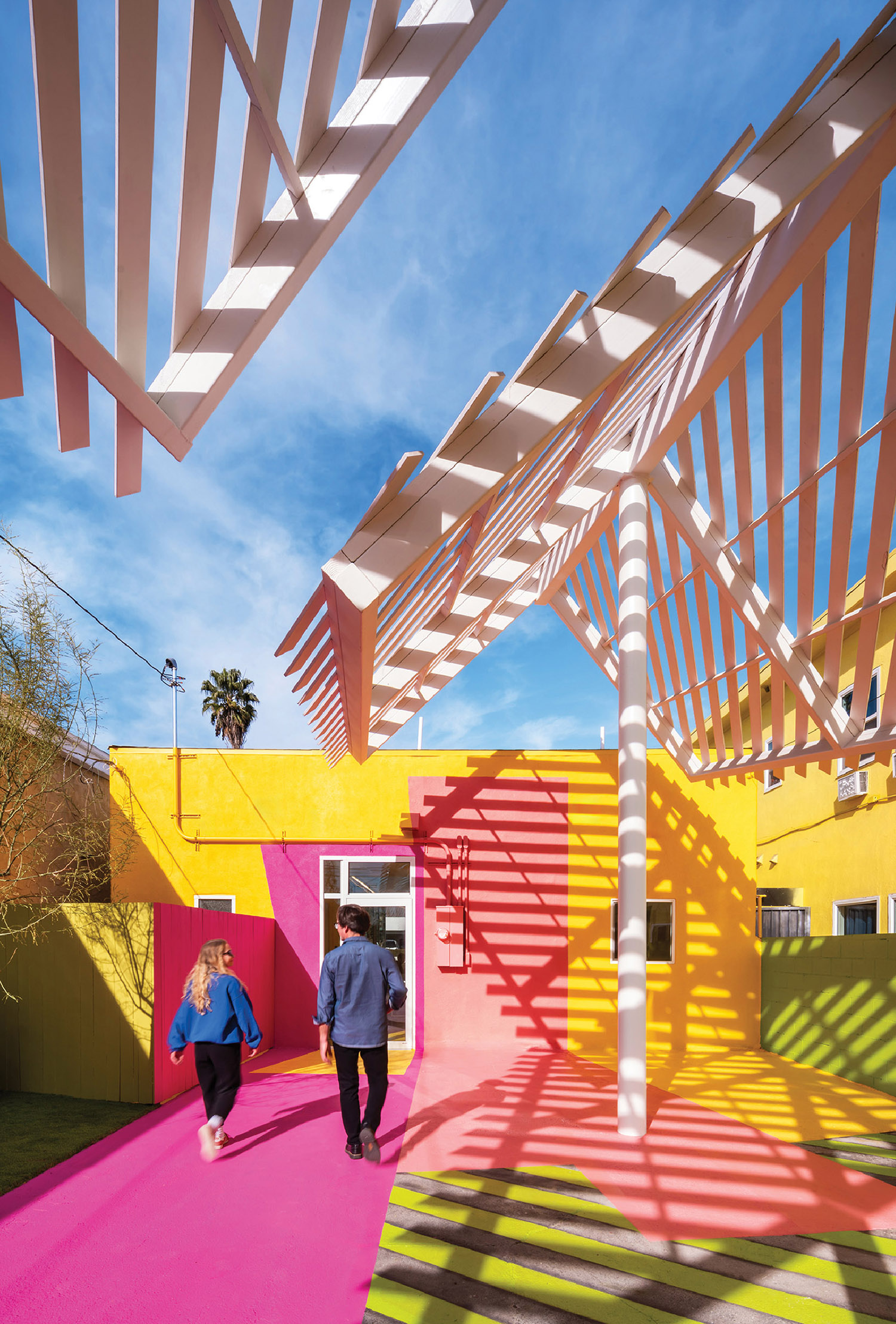 A couple walking down a pink walkway.