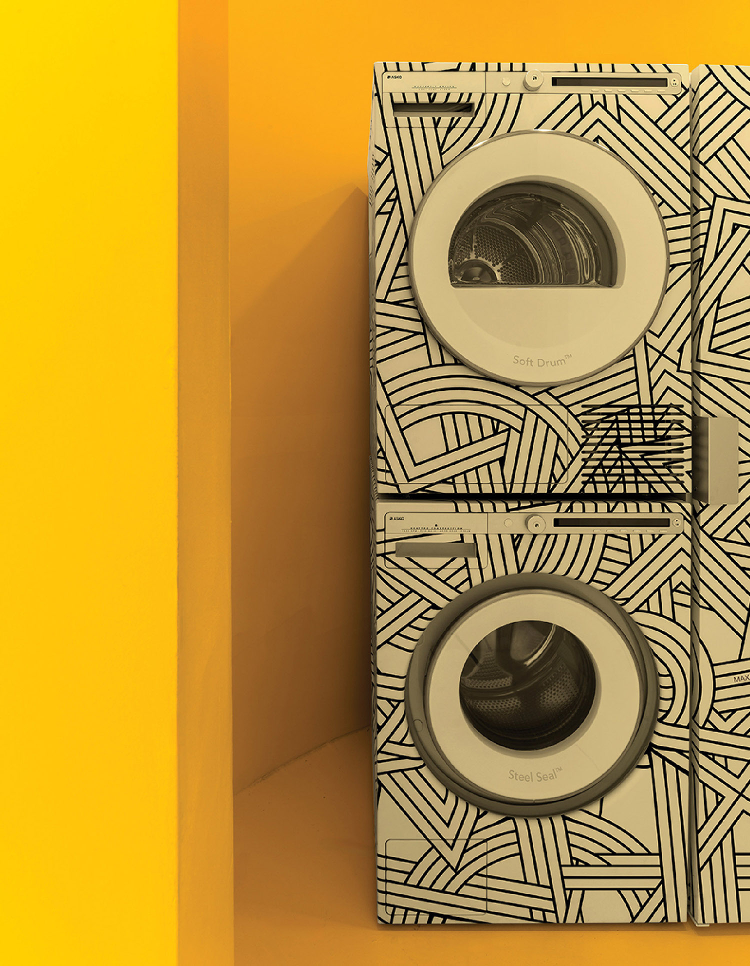 A pair of white and black washers on a yellow wall.