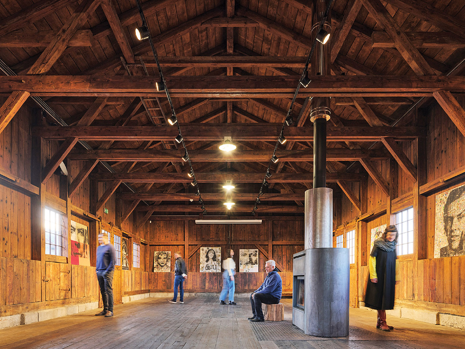 A group of people standing in a large room.