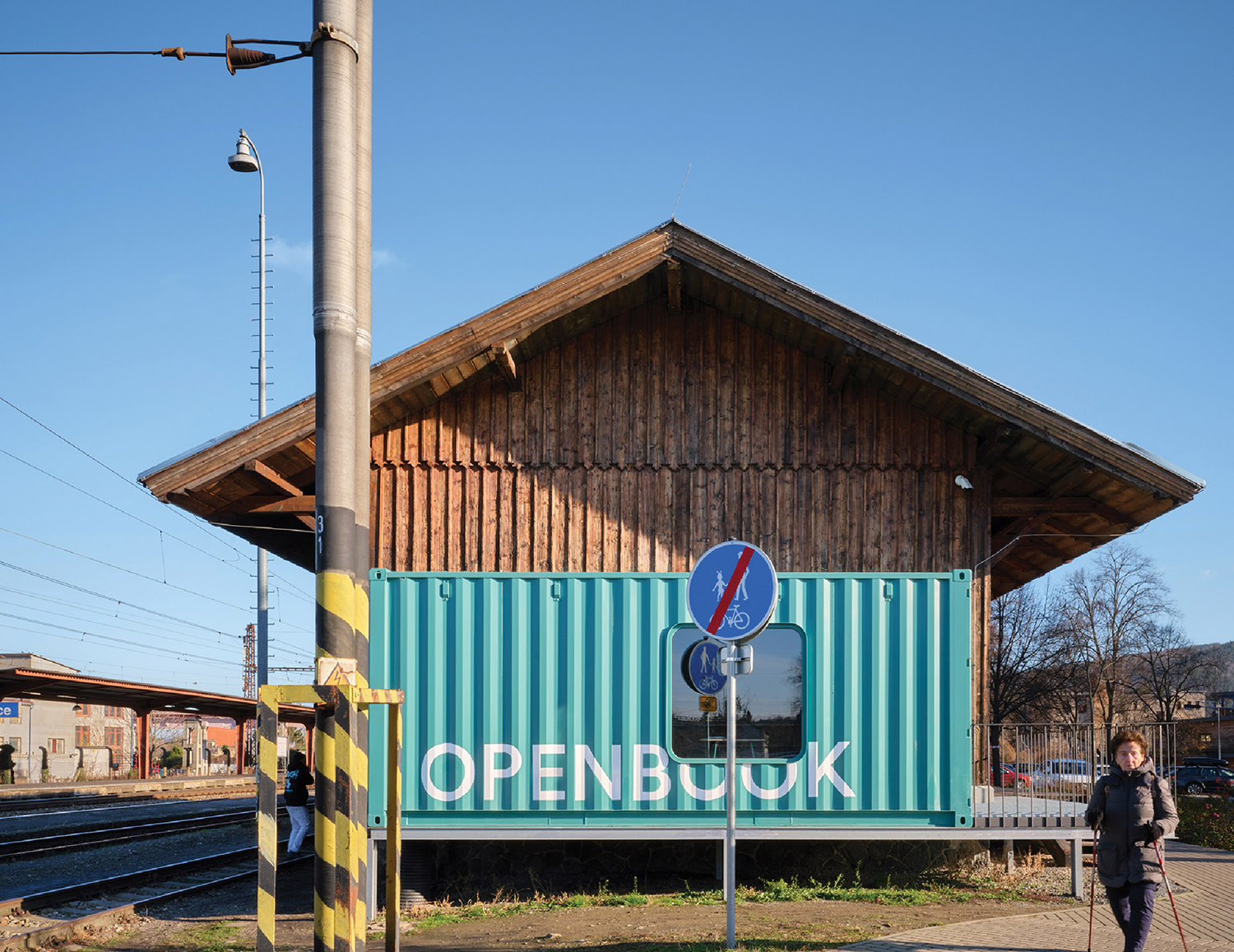 A train station with a train on the tracks.