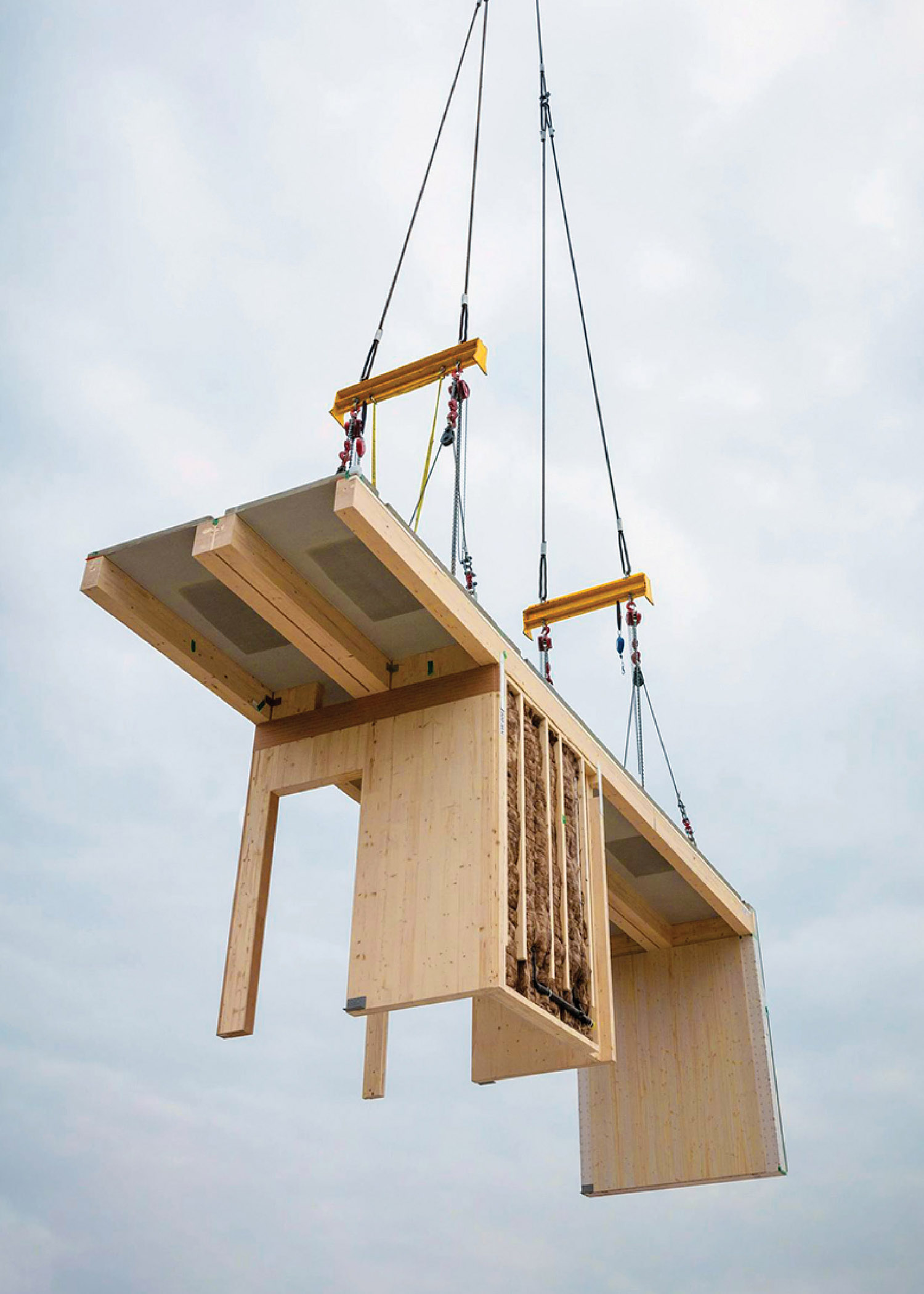 A crane is lifting a wooden structure into place.