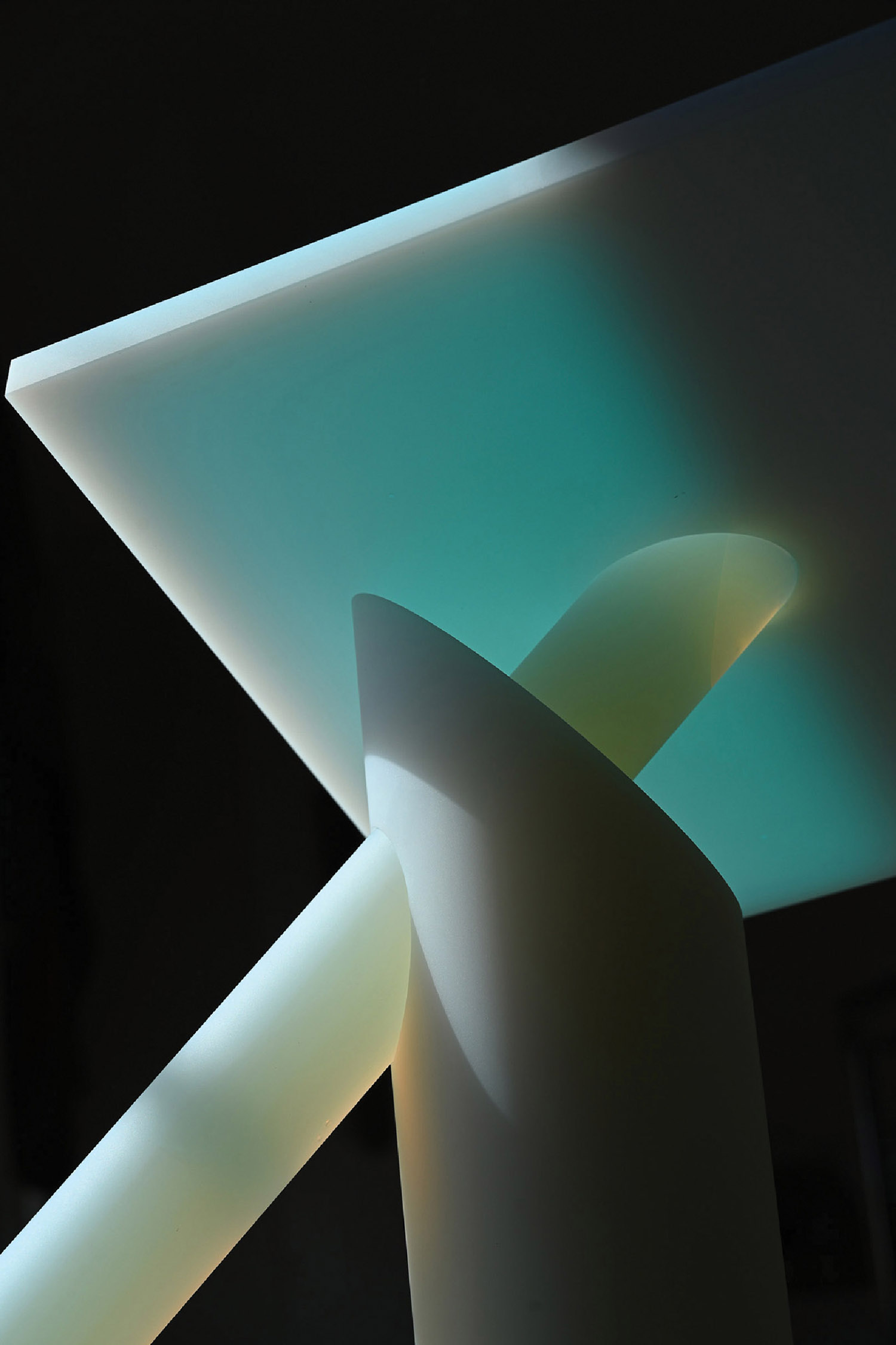 A white sculpture with a light coming from it.