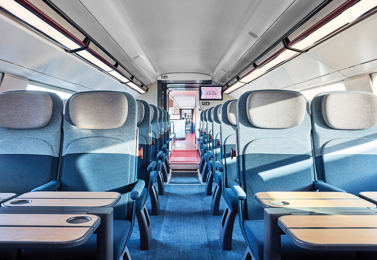 A bus with a table and chairs inside.