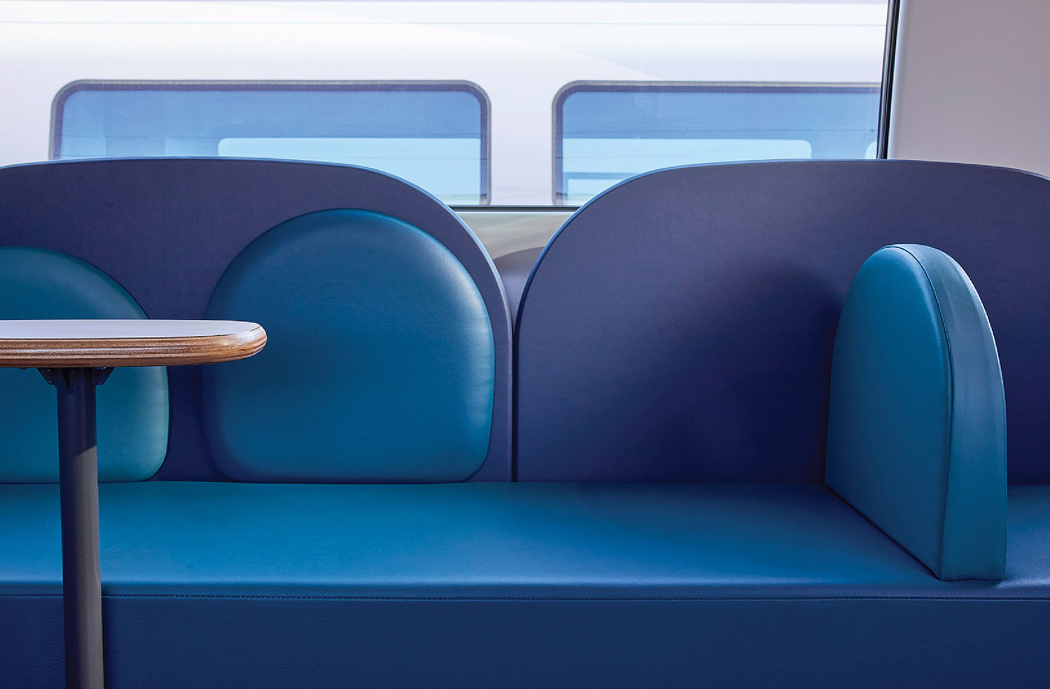 A table and chairs in a train car.