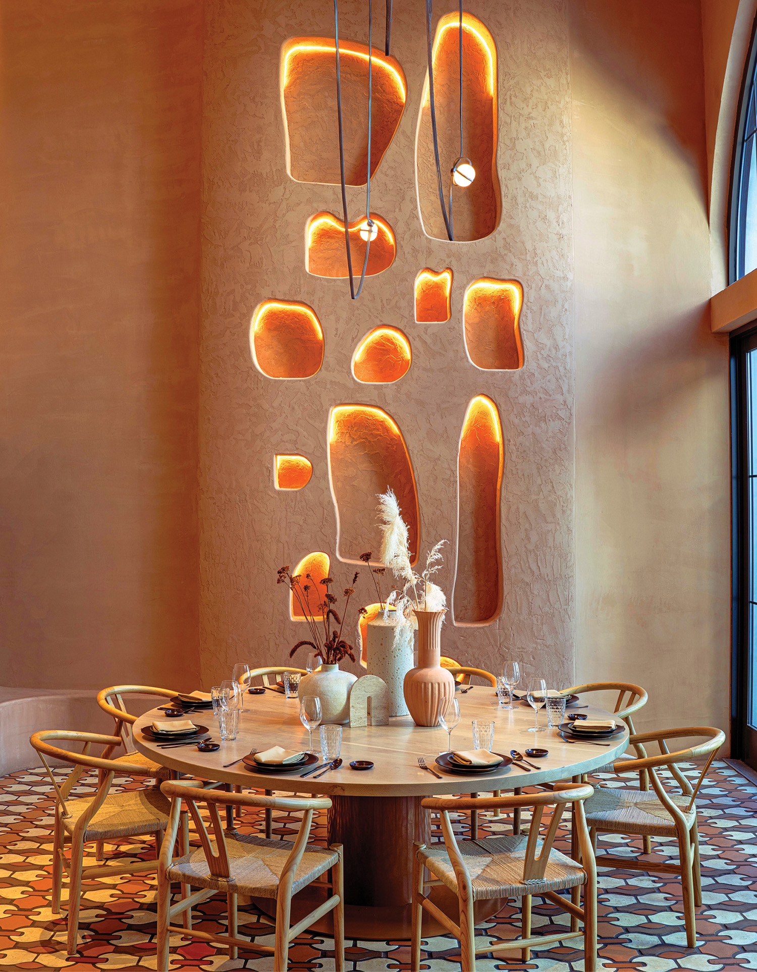 A dining room with a table and chairs.