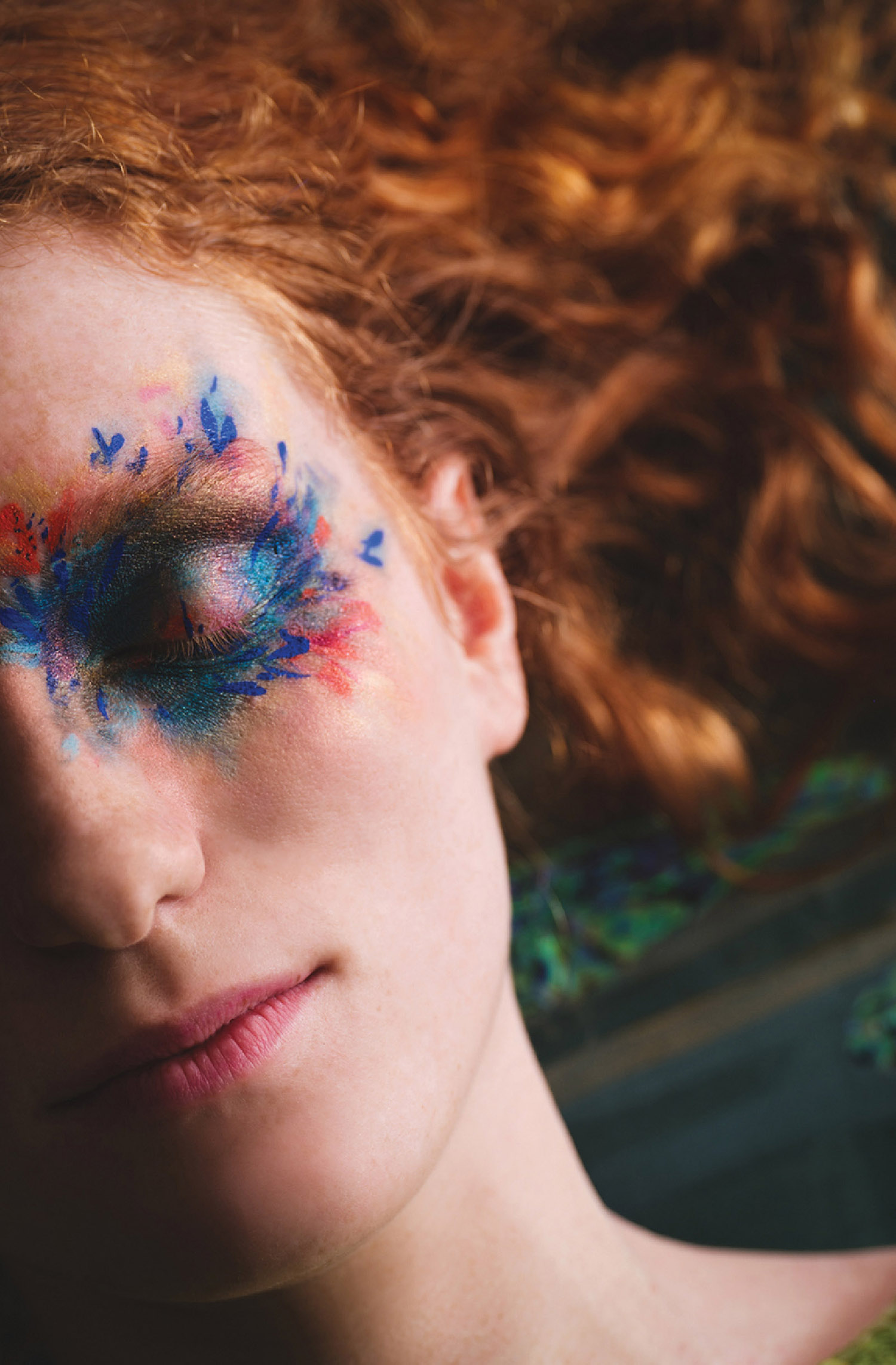 A woman with a painted face and hair.