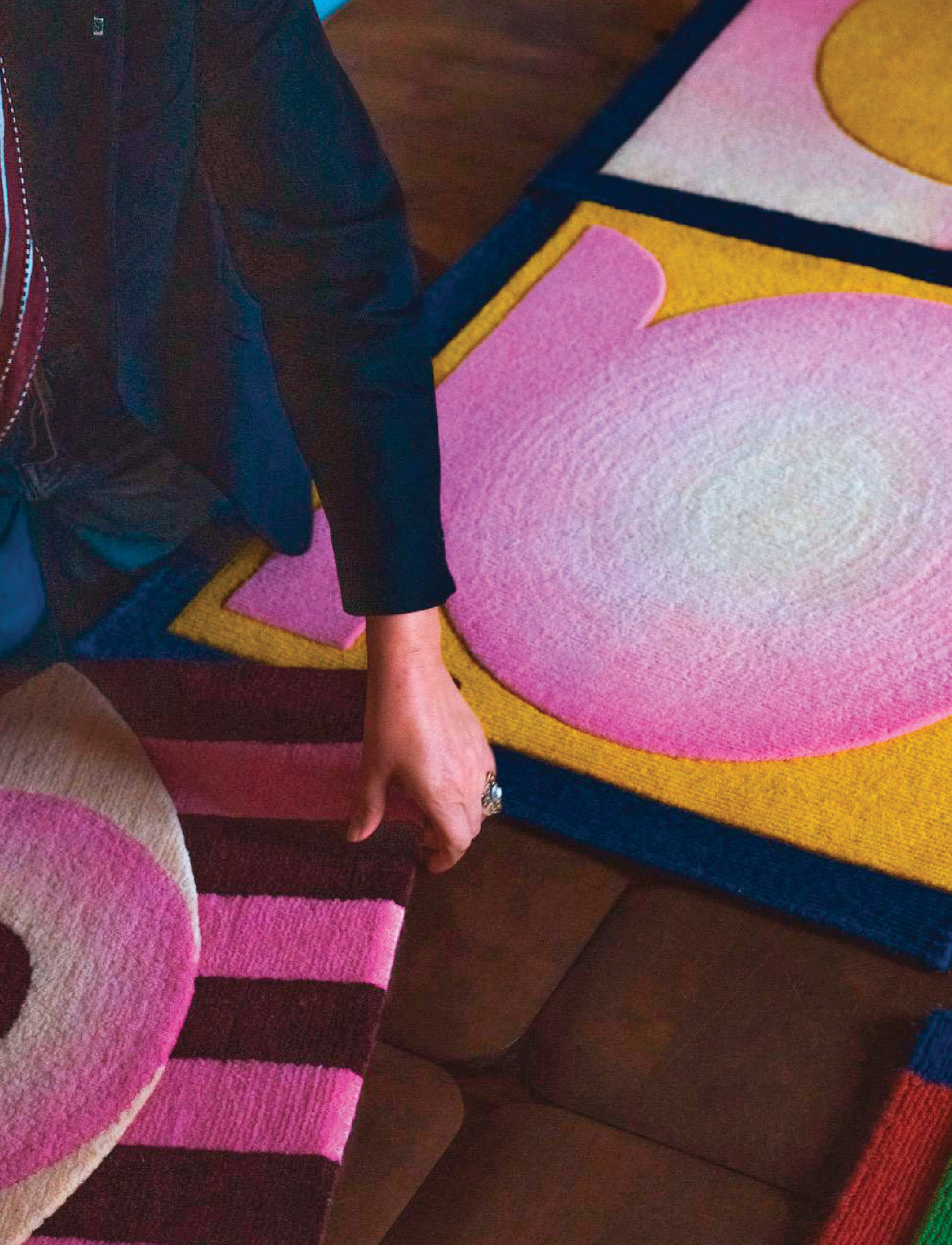 A woman is making a rug with yarn.