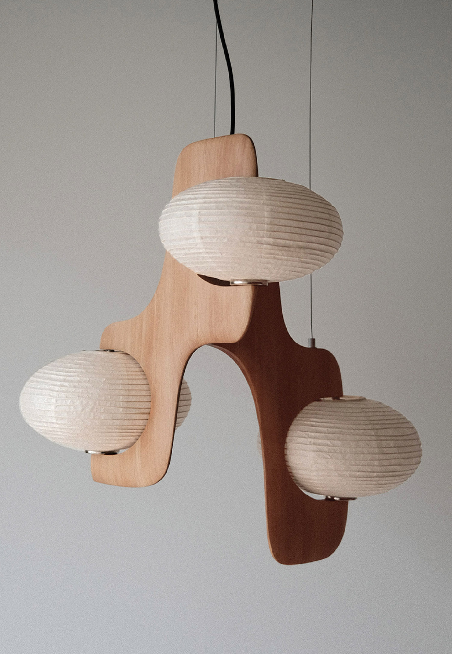 A wooden lamp hanging from a ceiling.