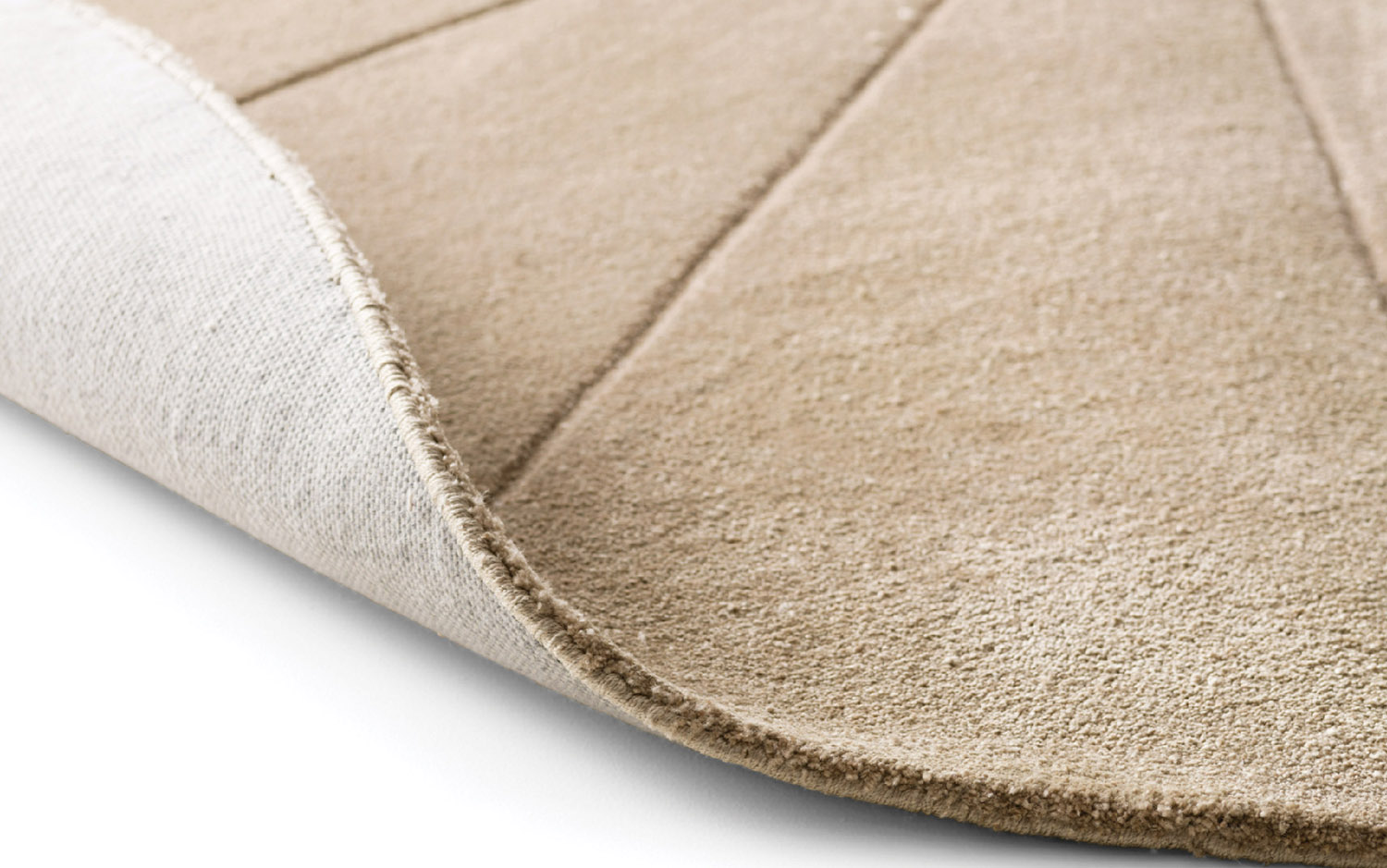 A beige rug with a white background.