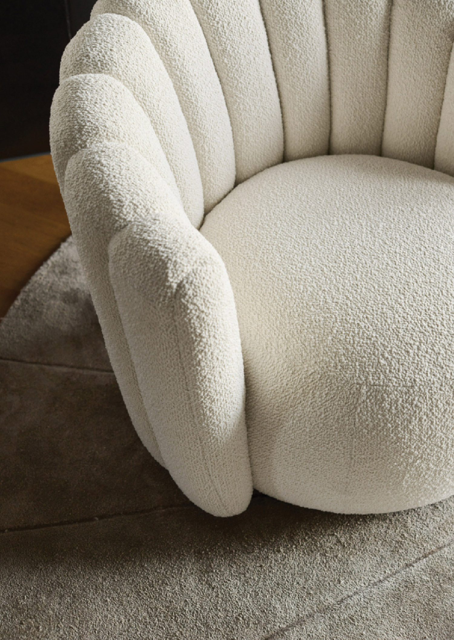 A white chair with a white pillow on it.