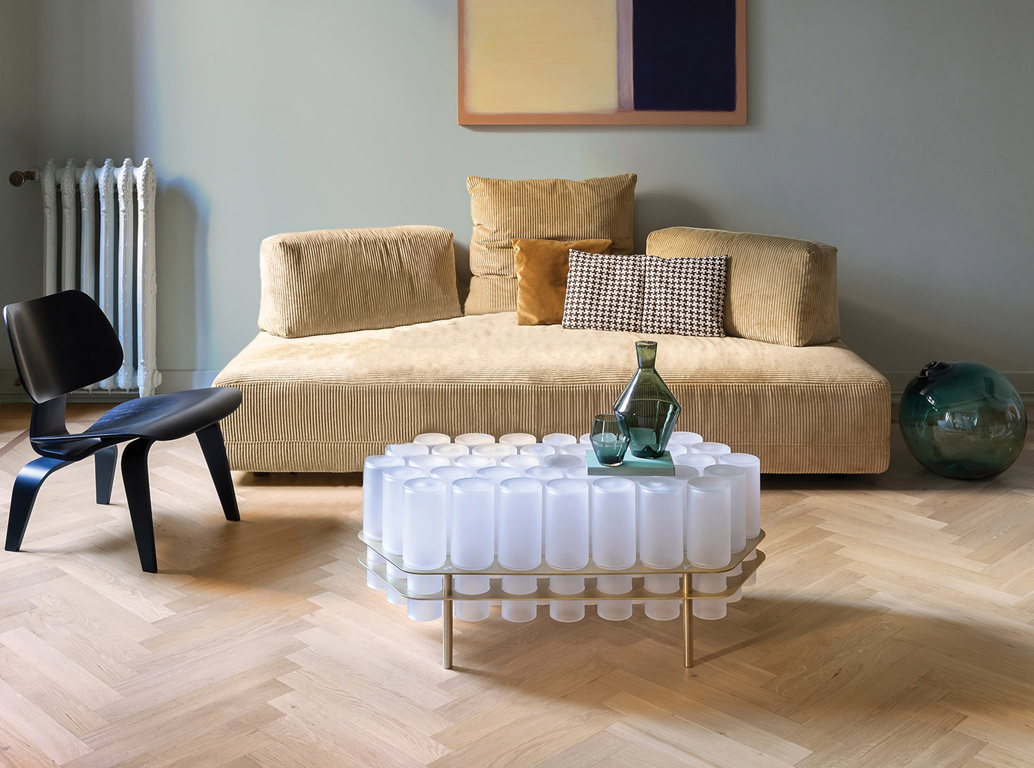 A couch and a table with bottles of wine on it.