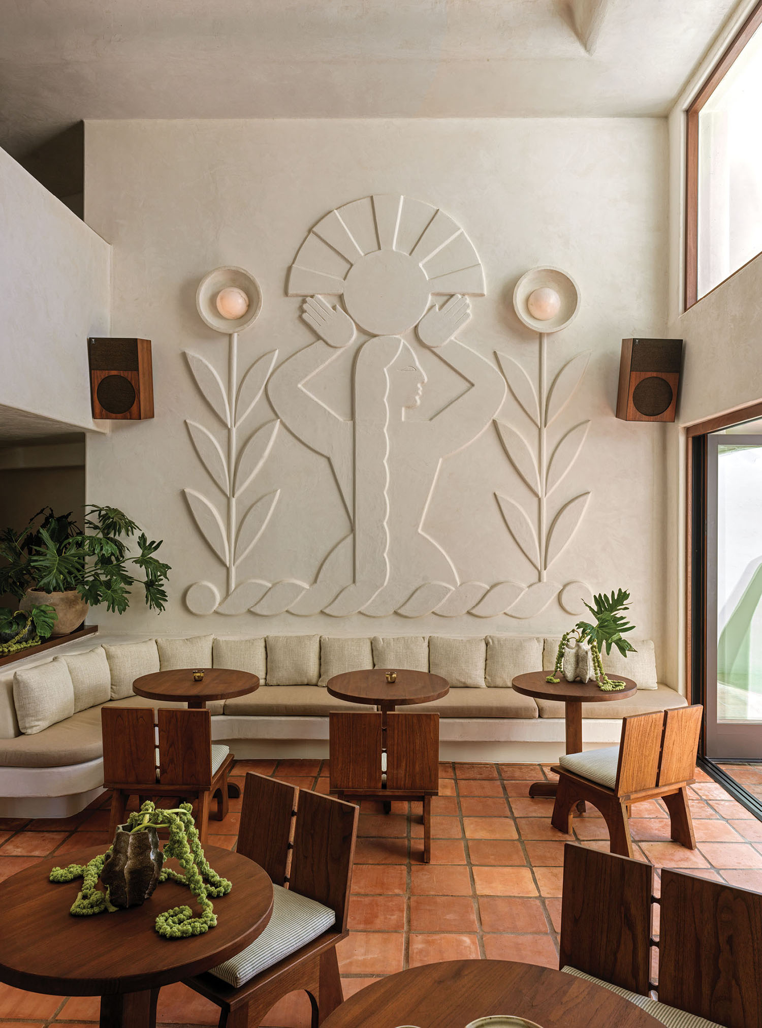 A living room with a large wall mural.