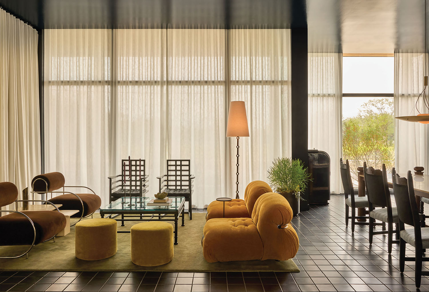 A living room with a large window and a table.